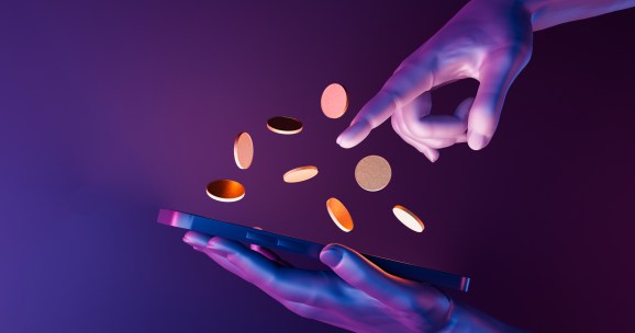 3d hands holding a cell phone with coins on the screen. neon lights. futuristic concept of play to earn, video games, technology, metaverse and crypto.